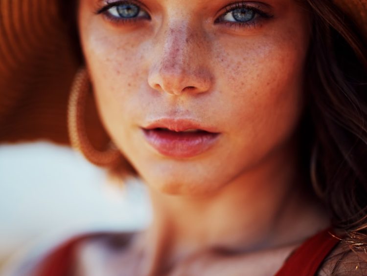 woman wearing sun hat and sleeveless top